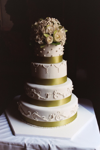 This stunning four tiered rolled fondant wedding cake was decorated with 