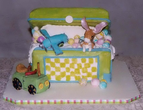 Baby Birthday Cake on Baby S Toy Chest Is Filled With A Toy Airplane A Baby S Blanket